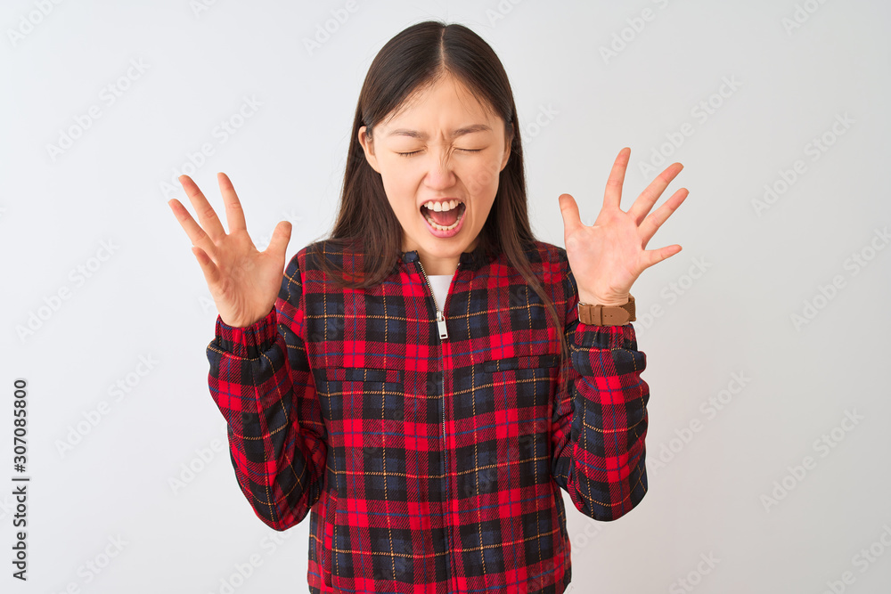 Young chinese woman wearing casual jacket standing over isolated white background celebrating mad and crazy for success with arms raised and closed eyes screaming excited. Winner concept Young chinese woman wearing casual jacket standing over isolated white background celebrating mad and crazy for success with arms raised and closed eyes screaming excited. Winner concept