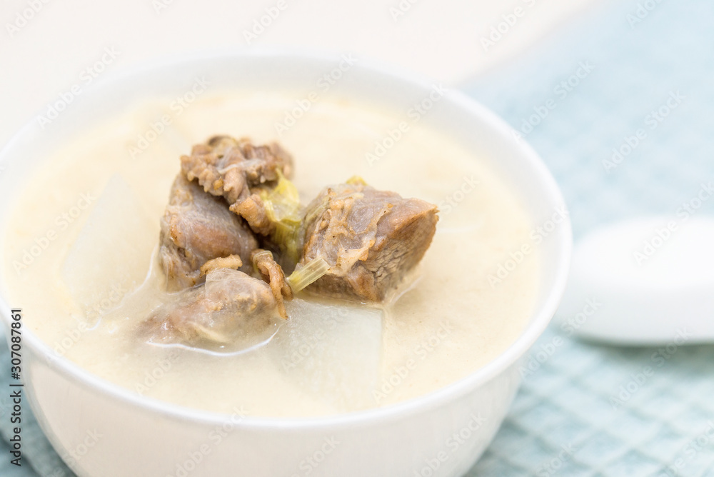 A bowl of mutton stew with radishes was set on the table A bowl of mutton stew with radishes was set on the table