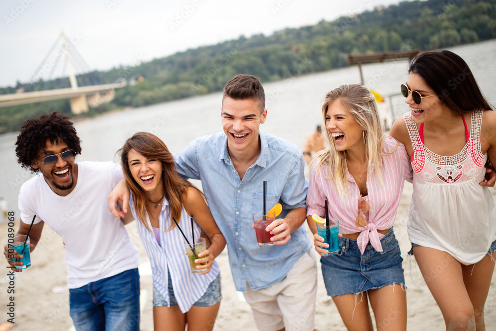 Group of friends having fun on the beach. Summer holidays, vacation and people concept. Group of friends having fun on the beach. Summer holidays, vacation and people concept.