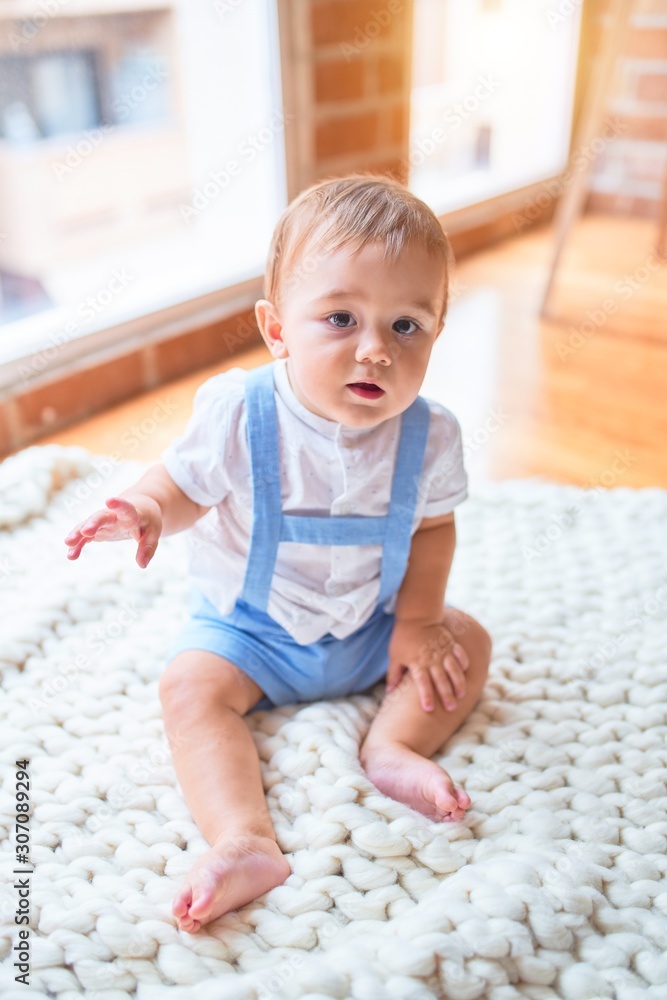 Beautiful toddler sitting on the blanket at kindergarten Beautiful toddler sitting on the blanket at kindergarten
