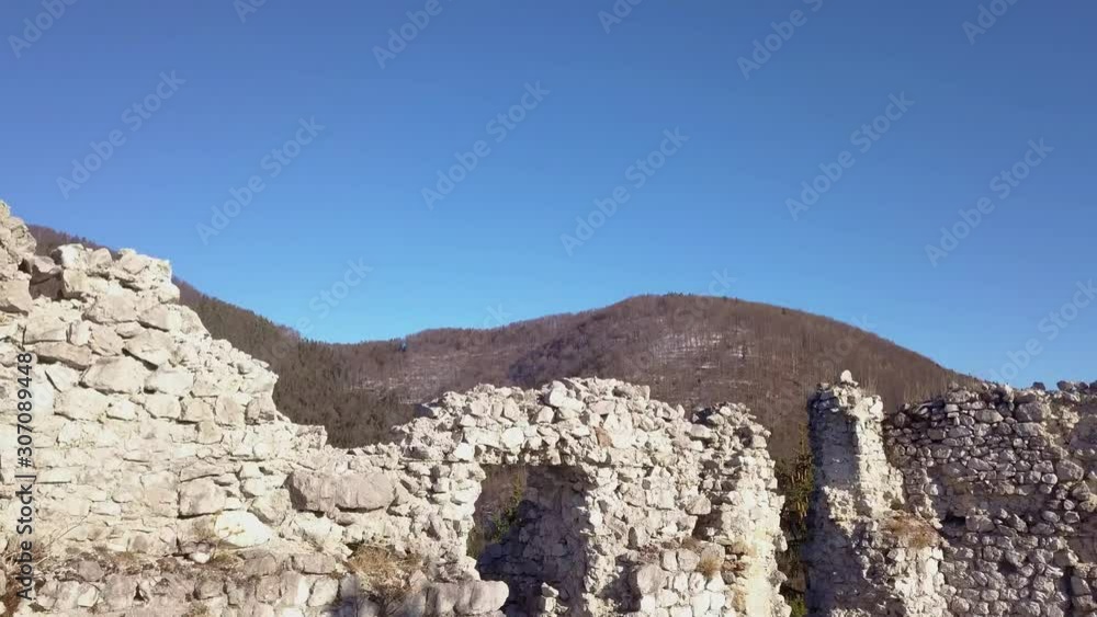 Aerial: Lifting up in front of ancient castle remaining stone walls. Filming wonderful Slovenian countryside nature on sunny winter evening. Aerial: Lifting up in front of ancient castle remaining stone walls. Filming wonderful Slovenian countryside nature on sunny winter evening.