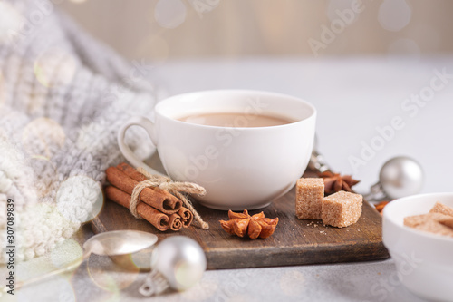 White cup with coffee and marshmallow  sweater  cinnamon. Cozy christmas composition. Hygge concept Soft focus