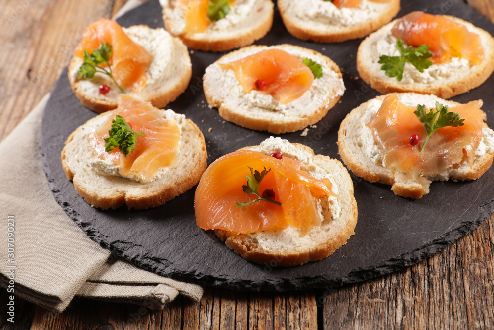 finger food, bread toast with cream and smoked salmon