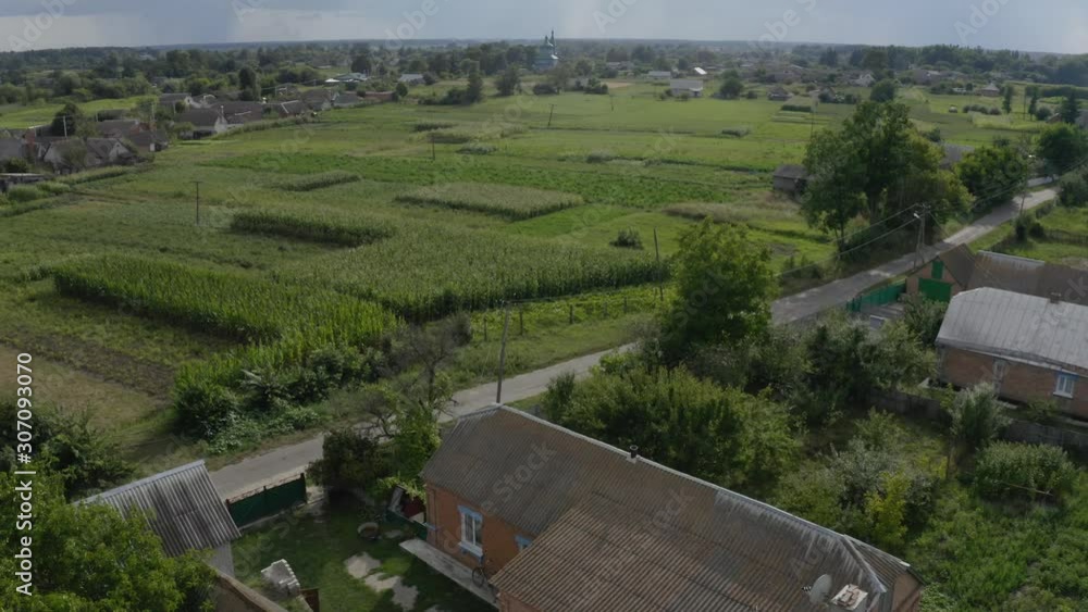 Ukraine - A lovely village in the valley with residential houses, vegetation, and a church nearby - wide shot Ukraine - A lovely village in the valley with residential houses, vegetation, and a church nearby - wide shot