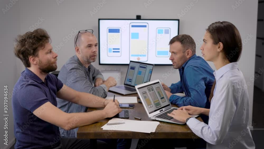 four people are sitting in meeting room in office of development company of apps for cell phones four people are sitting in meeting room in office of development company of apps for cell phones