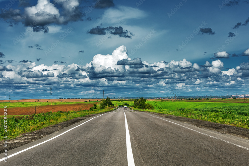 speed highway through the field. asphalt-paved road - obrazy, fototapety, plakaty 