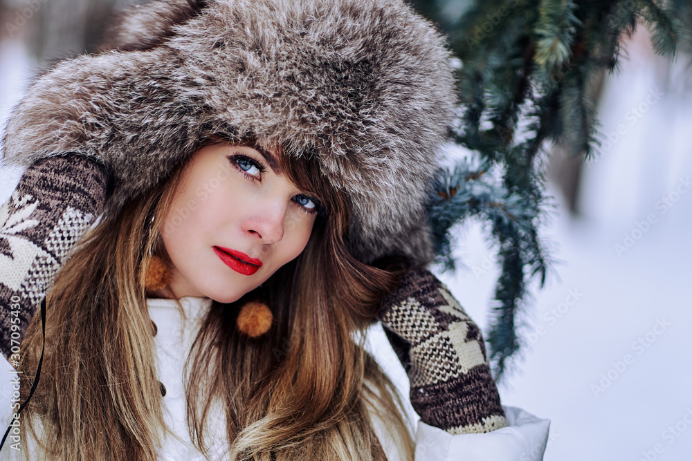 young woman in winter in a fur hat. winter mood young woman in winter in a fur hat. winter mood
