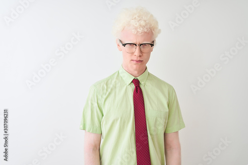Young albino businessman wearing shirt and tie standing over isolated white background skeptic and nervous, frowning upset because of problem. Negative person.