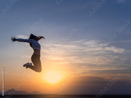 Wallpaper Mural Free young woman slim body at golden sunset. Freedom and success concept,relaxing and enjoying a sunny summer holiday. Torontodigital.ca