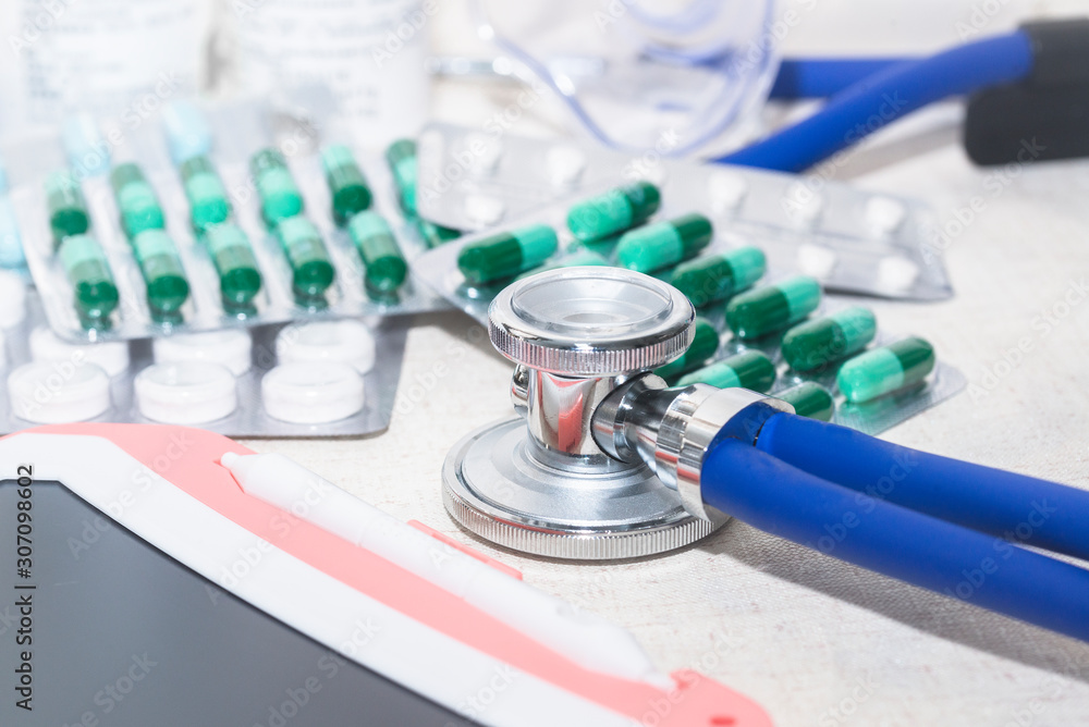 Stethoscopes on the table, empty capsules, medicines, bottles and medical supplies Stethoscopes on the table, empty capsules, medicines, bottles and medical supplies