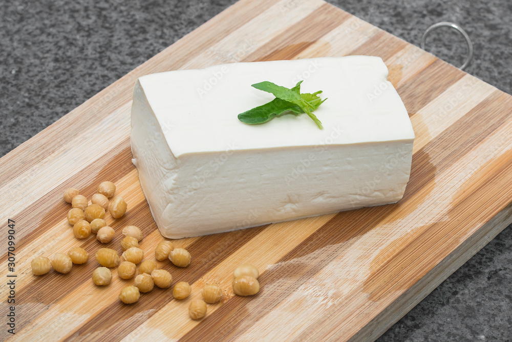 Place a slice of tender tofu and soy on a chopping board Place a slice of tender tofu and soy on a chopping board