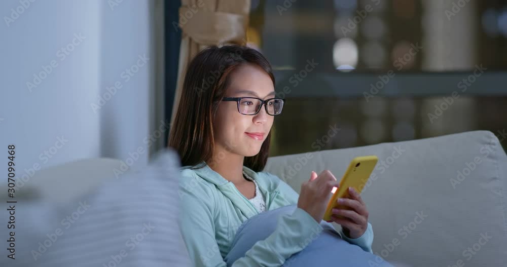 Woman wear glasses and use of mobile phone at home Woman wear glasses and use of mobile phone at home
