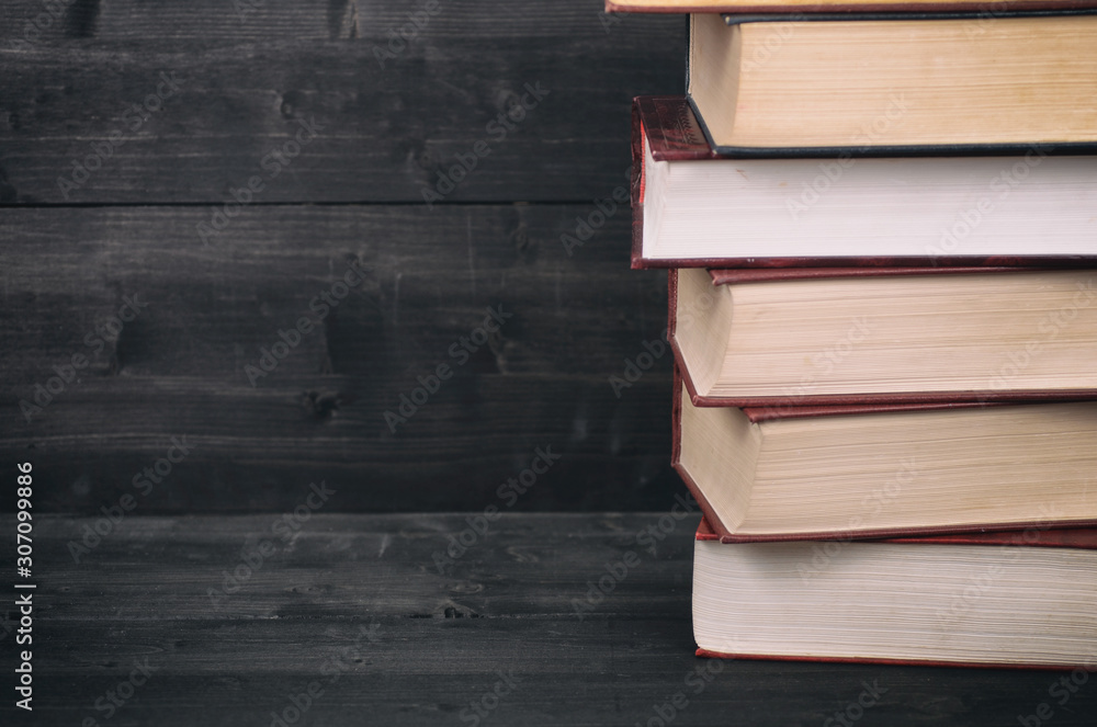 Old Law books on the black wooden background. Old Law books on the black wooden background.