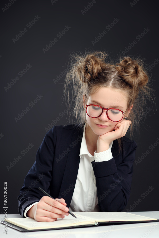 Pretty good schoolgirl sitting at the table. Pretty good schoolgirl sitting at the table.