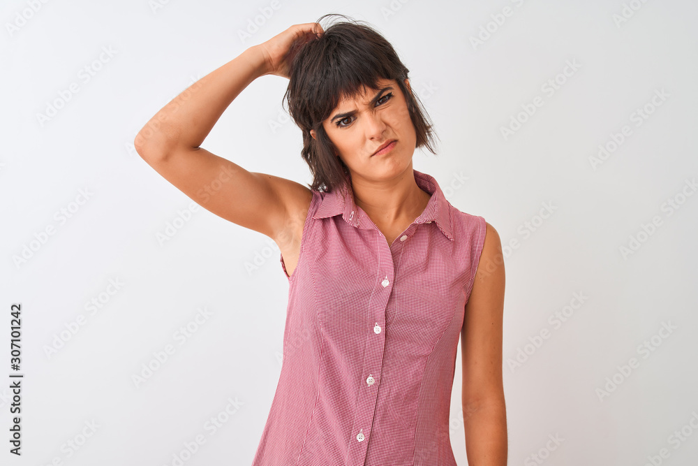 Young beautiful woman wearing red summer shirt standing over isolated white background confuse and wonder about question. Uncertain with doubt, thinking with hand on head. Pensive concept. Young beautiful woman wearing red summer shirt standing over isolated white background confuse and wonder about question. Uncertain with doubt, thinking with hand on head. Pensive concept.