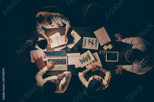 Top above high angle view of smart clever hardworking business people top executive managers working with data preparing report presentation at late night workplace workstation