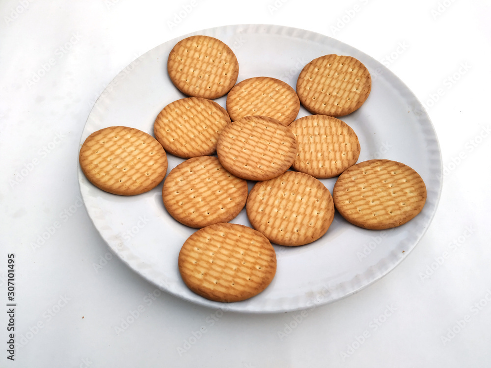 fresh healthy wheat biscuits put in a plate isolated on white background fresh healthy wheat biscuits put in a plate isolated on white background