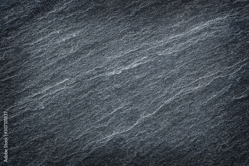 Dark grey black slate stone abstract background or texture.