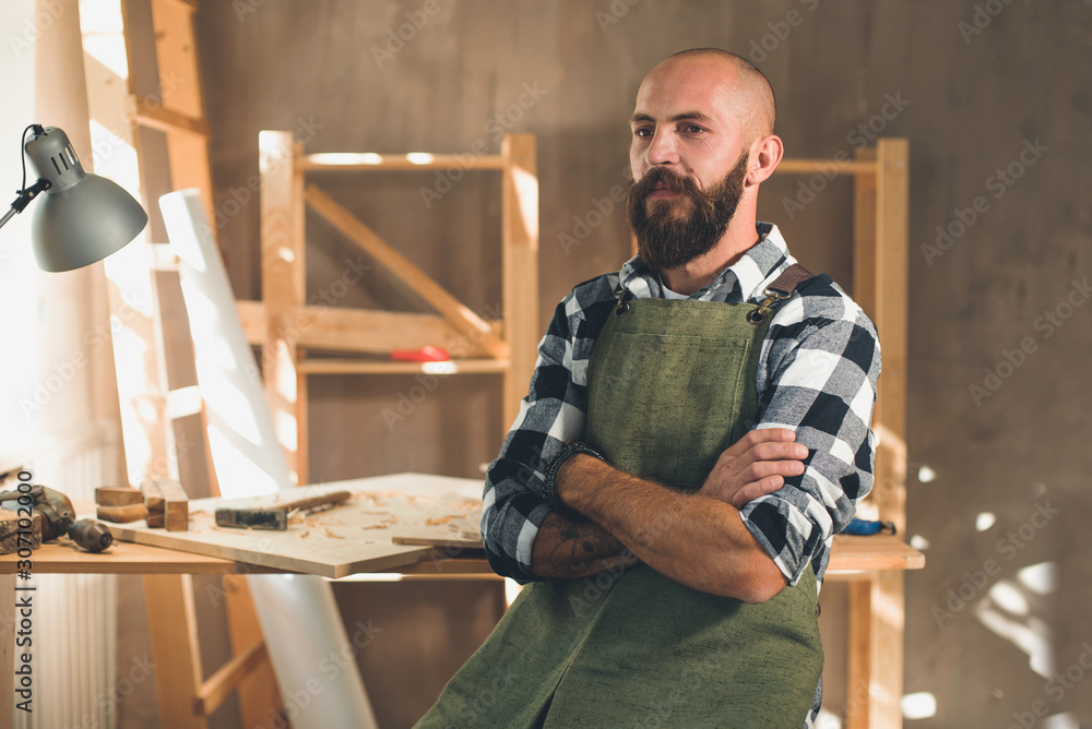 Portrait of a young male carpenter who works in his workshop. Portrait of a young male carpenter who works in his workshop.