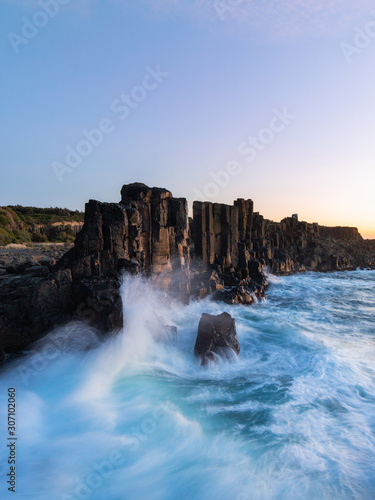 Motions of wave water around the rock formation on the coastline.