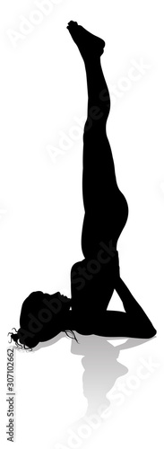 A silhouette of a woman in a yoga or pilates pose