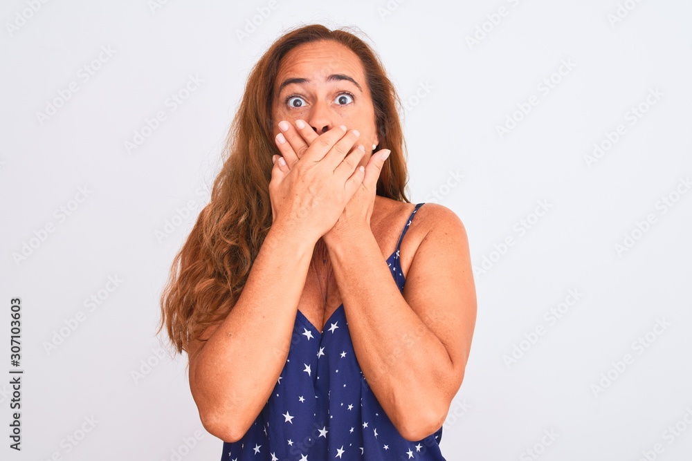 Middle age mature woman standing over white isolated background shocked covering mouth with hands for mistake. Secret concept. Middle age mature woman standing over white isolated background shocked covering mouth with hands for mistake. Secret concept.