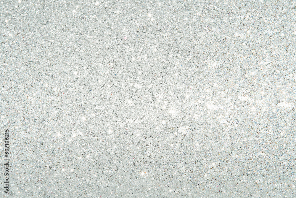 Silver Sparkling Lights Festive background with texture. Abstract Christmas twinkled bright bokeh defocused and Falling stars. Winter Card or invitation	