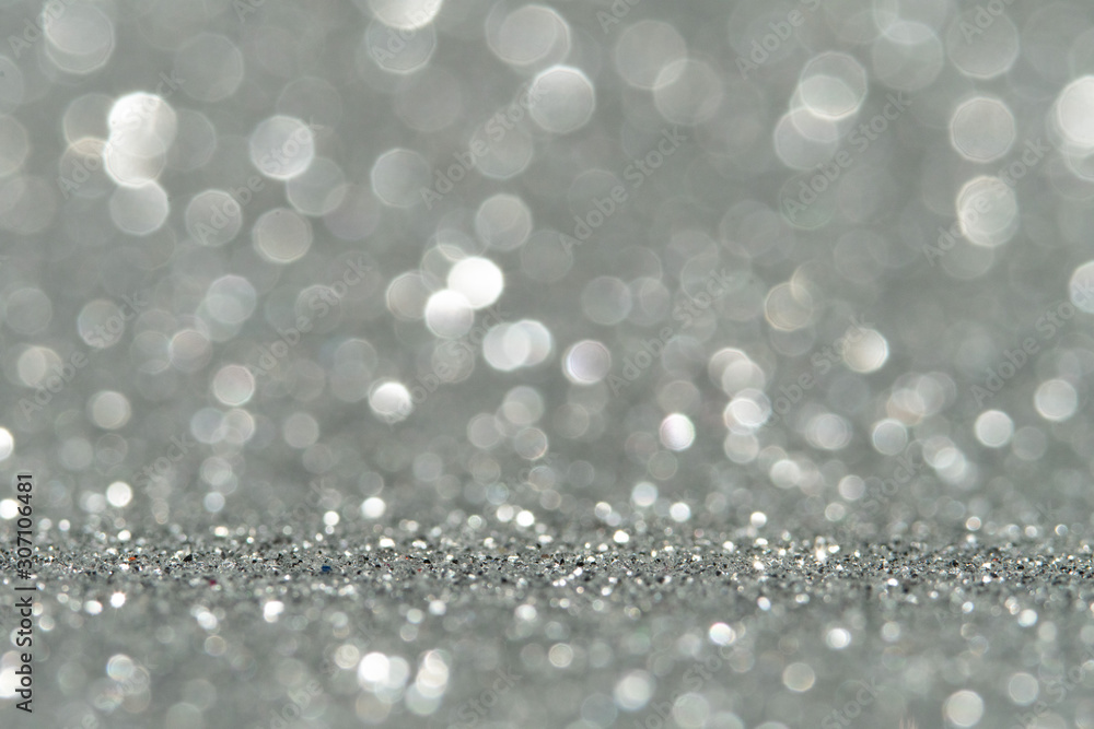Silver Sparkling Lights Festive background with texture. Abstract Christmas twinkled bright bokeh defocused and Falling stars. Winter Card or invitation Silver Sparkling Lights Festive background with texture. Abstract Christmas twinkled bright bokeh defocused and Falling stars. Winter Card or invitation
