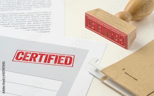 A red stamp on a document - Certified