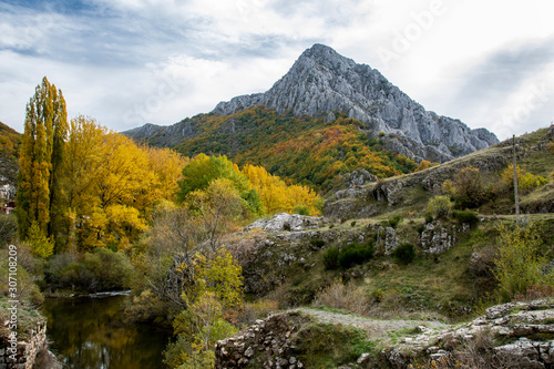 Autumnal landscape on the Curueño river. Cueto Ancino in the background, León, Spain photo