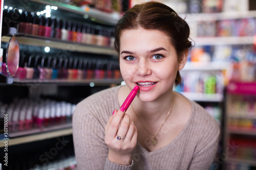 Smiling female looking for make-up items