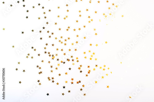 Golden stars on white background. Flat lay  top view.