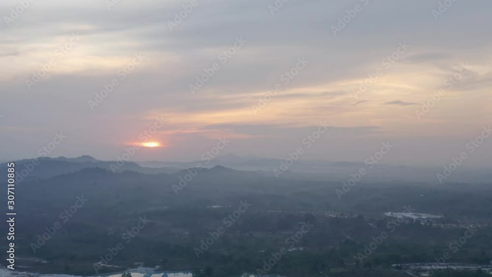 Aerial dolly out view of Kaolin Lake mine pit area with buildings cloudy sky at sunrise Belitung island, Bangka Indonesia Aerial dolly out view of Kaolin Lake mine pit area with buildings cloudy sky at sunrise Belitung island, Bangka Indonesia