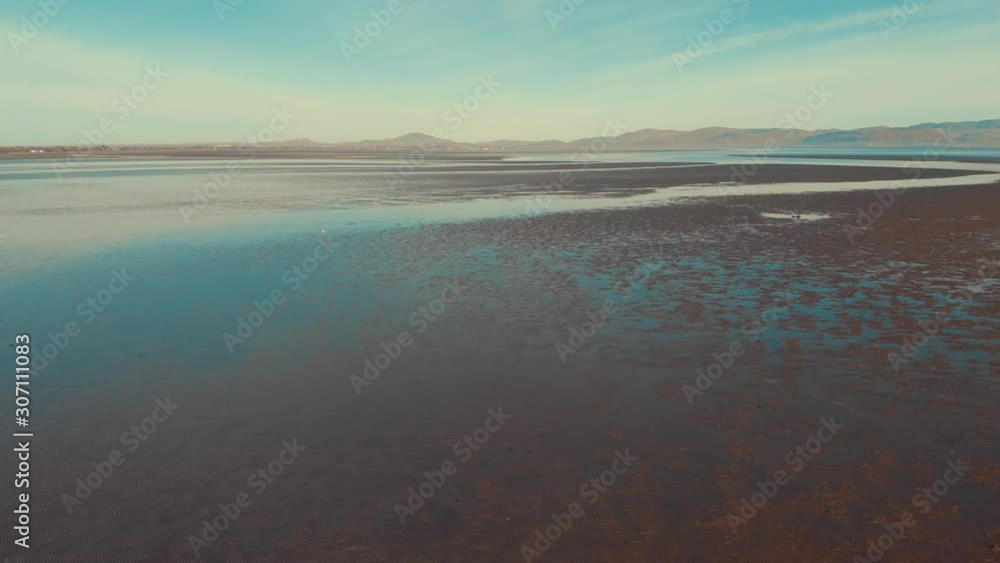 Drone flying backwards revealing yacht sitting on sand during low tide. Annagassan, Co. Louth, Ireland. Drone flying backwards revealing yacht sitting on sand during low tide. Annagassan, Co. Louth, Ireland.