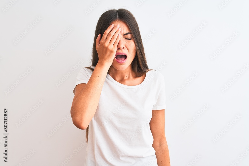 Young beautiful woman wearing casual t-shirt standing over isolated white background Yawning tired covering half face, eye and mouth with hand. Face hurts in pain. Young beautiful woman wearing casual t-shirt standing over isolated white background Yawning tired covering half face, eye and mouth with hand. Face hurts in pain.