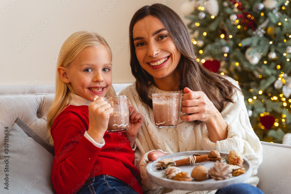 Happy family drinking cocoa on Christmas eve