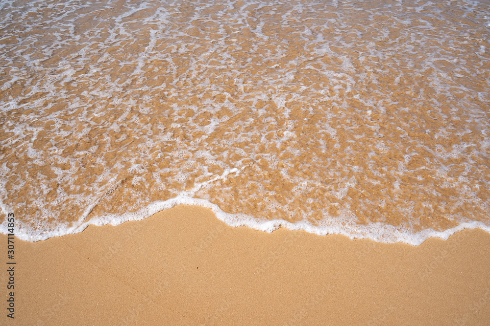Waves lap up on a sandy beach creating sea foam. Taken in Sri Lanka on the Indian Ocean Waves lap up on a sandy beach creating sea foam. Taken in Sri Lanka on the Indian Ocean