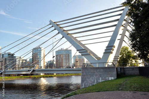 View of a modern bridge in a modern area of the city. It can be used in banners, posters, for printing on fabric, bag, mug, calendar, as background, etc.