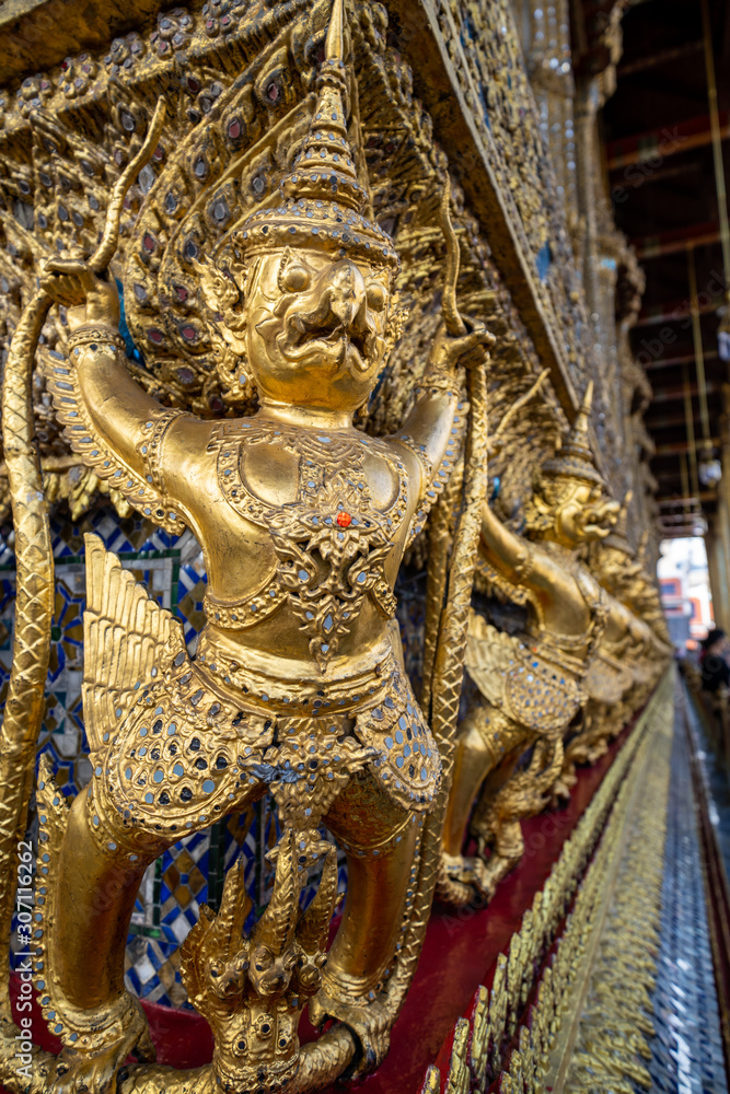 Grand Palace in Bangkok at the Wat Phra Kaew  - close up of Garuda and Nagas, at the outside of Temple of Emerald Buddah