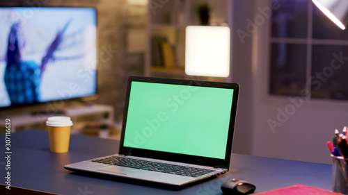Desktop computer with green screen on home office. © DC Studio