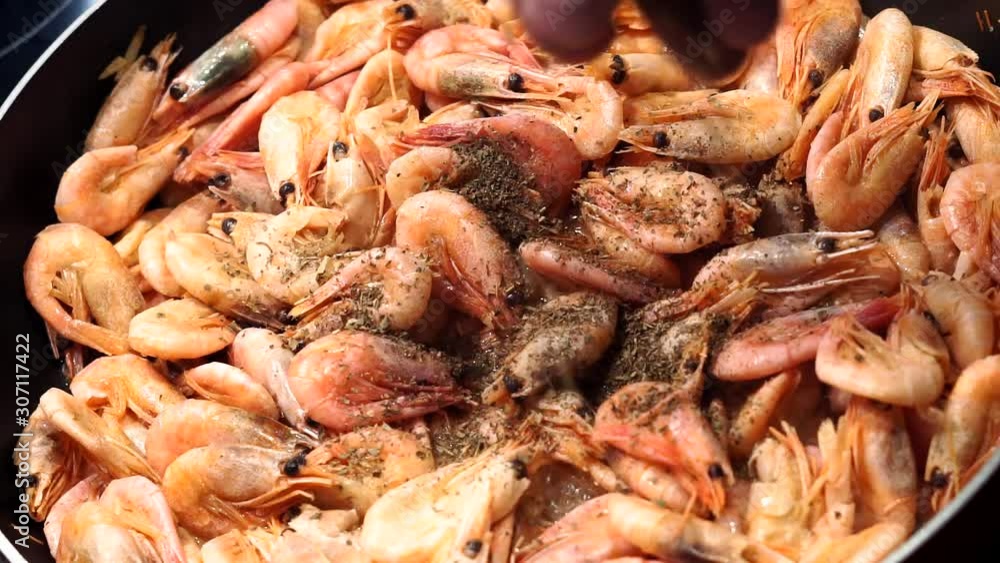 cooking shrimp, sea food, adding spices, black pepper dill cooking shrimp, sea food, adding spices, black pepper dill
