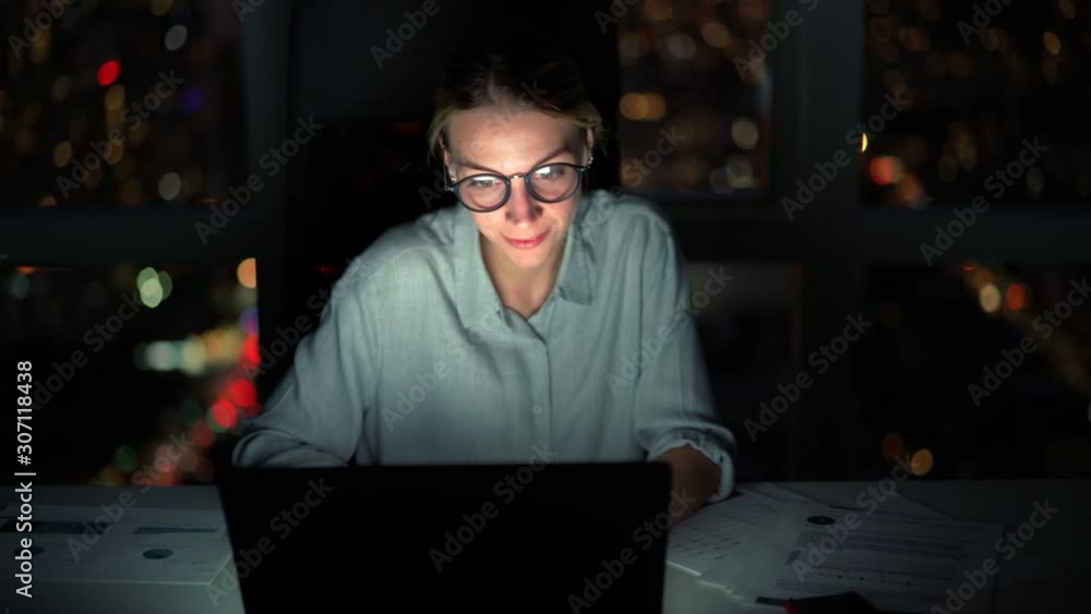 Business woman keyboarding on laptop computer doing job overworking at evening, female financial expert reading website information on netbook before deadline sitting at desktop late Business woman keyboarding on laptop computer doing job overworking at evening, female financial expert reading website information on netbook before deadline sitting at desktop late