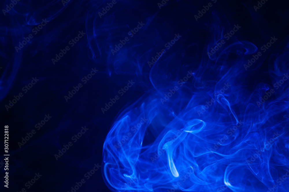 Obraz premium Blue smoke on black background.