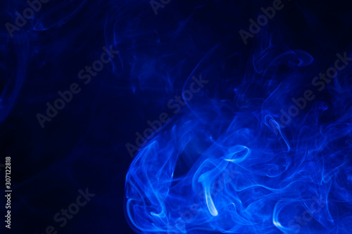 Blue smoke on black background.