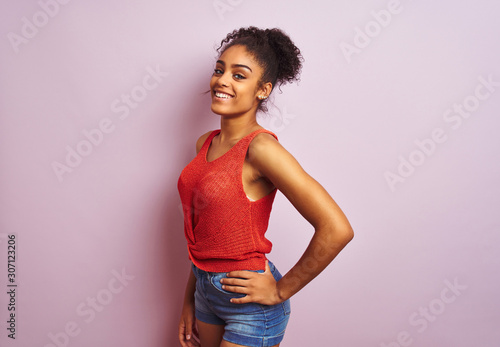 Young beautiful african american woman standing wearing casual orange t-shirt