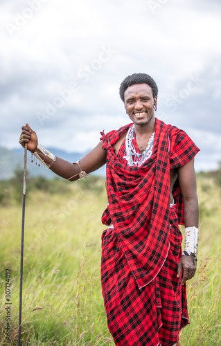 handsome maasai warrior in savannah