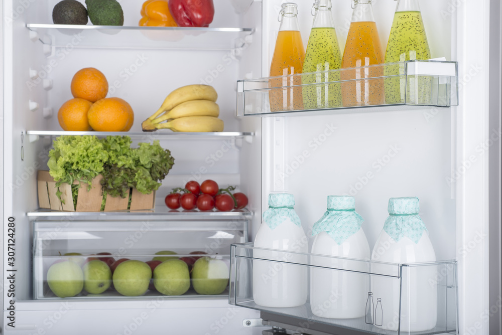Open fridge full of fresh fruits and vegetables Open fridge full of fresh fruits and vegetables