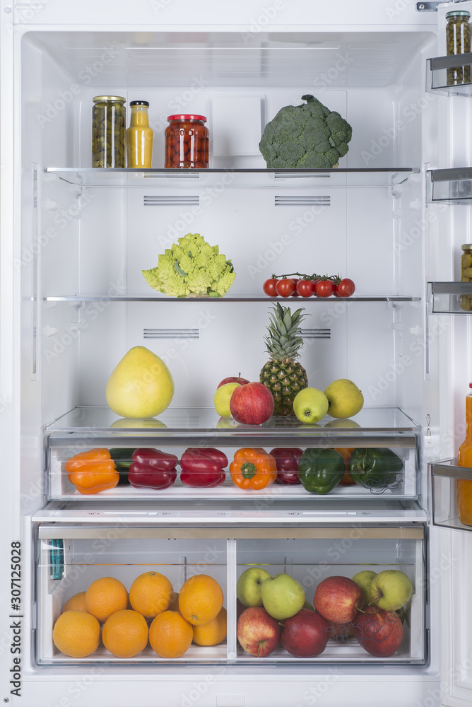 Open fridge full of fresh fruits and vegetables Open fridge full of fresh fruits and vegetables
