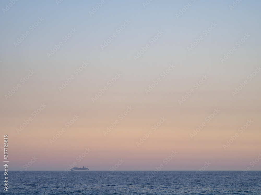 Passenger liner away on the horizon in the ocean.