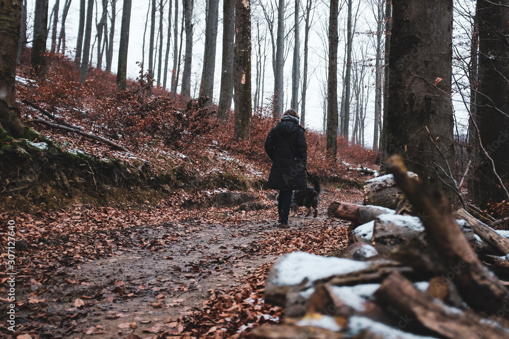 woman with dog in forest